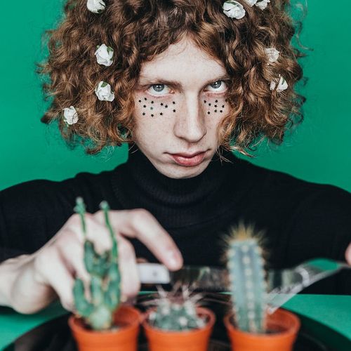 Person looking out a window at a vibrant green landscape, feeling refreshed.